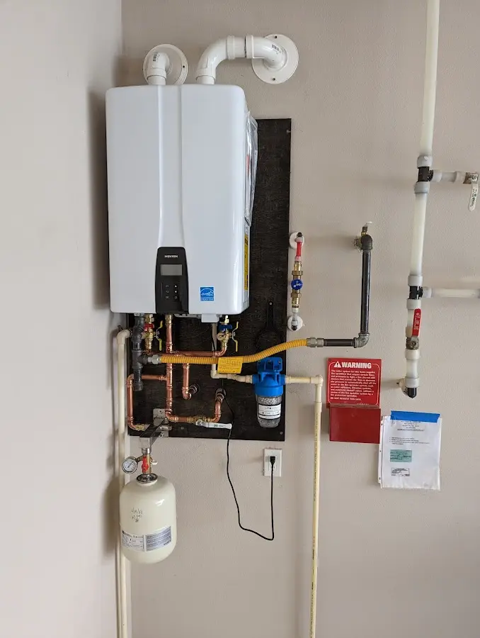 Professional plumber installing copper piping in a Park Forest home